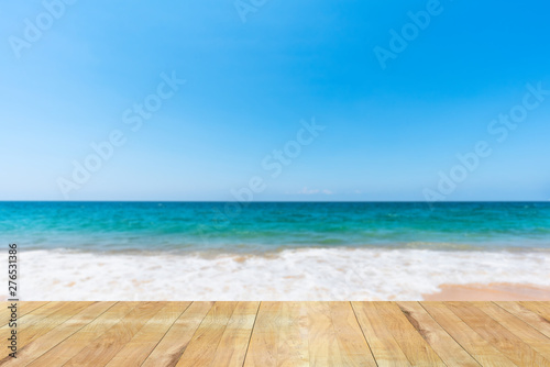wooden table with soft sea wave on sand beach and scenic natural seascape background