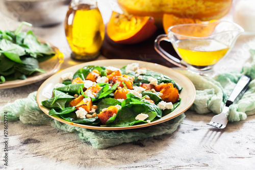 Roasted pumpkin salad with spinach and nuts