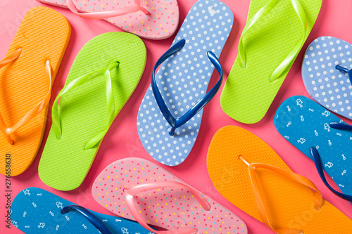 a lot of flip flop colored sandals, summer vacation on colored background, copy space top view