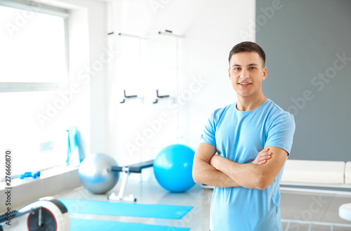 Young male physiotherapist in rehabilitation center
