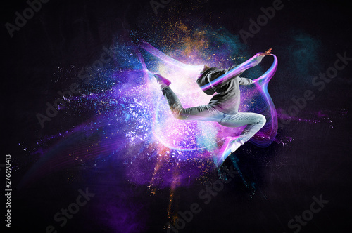 Modern female dancer jumping in hoodie with colourful splashes background. Mixed media