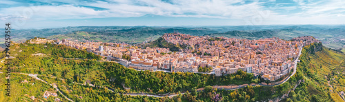 Panoramic view of the hills, the town of Enna on the valley with green meadows and forests in Sicily.