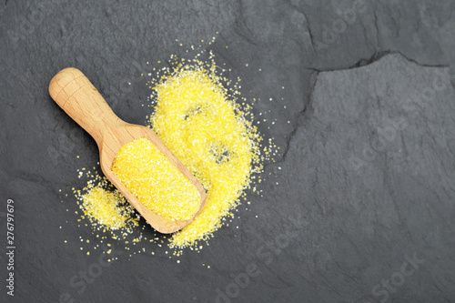 Top view of cornmeal in wooden scoop