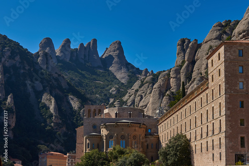 Benedictine monastery at the foot of the majestic mountains on a Sunny warm day.