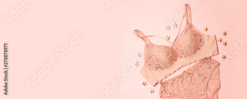 gently pink lace underwear with stars decor on a pink background. Congratulatory romantic concept for Valentine's Day