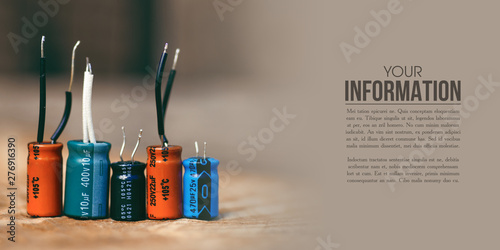 electrolytic capacitor electronic detal on wooden background