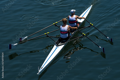 Two Male Rowers In A Double Racing Boat With Synchronous Oar Stroke