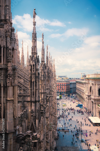 View of people enjoying Piazza del Duomo with the ornate architecture of the Milan Cathedral Lombardy, Italy