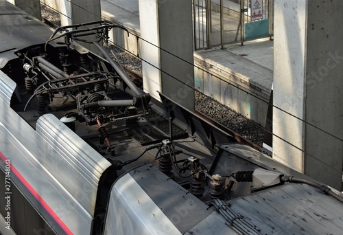 Picture of a train catenary connected to the electrical cables. Transportation with electrical energy background.