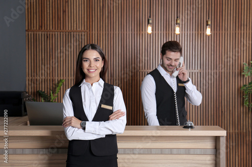 Receptionist at desk with colleague in lobby