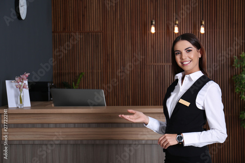 Portrait of receptionist at desk in lobby