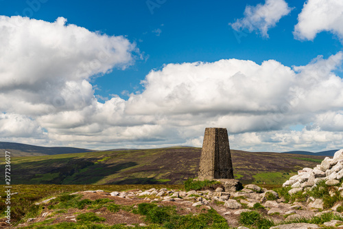 Marker on the Two Rock summit also known as Fairy Castle in Dublin Mountains, Ireland. Mountain landscape from Ticknock recreation site on a summer day.