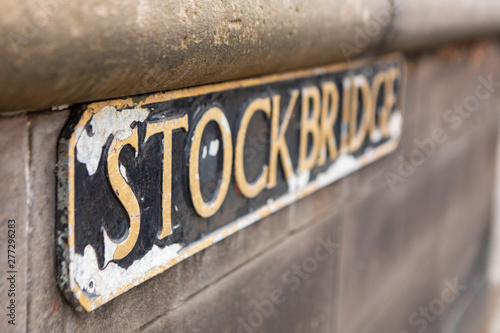 weathered street sign for the Stockbridge neighborhood with golden letters