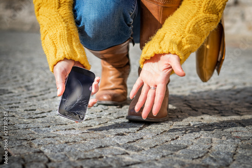 Woman feeling frustration from broken smartphone