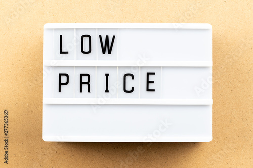 Light box with word low price on wood background