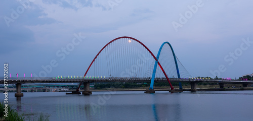 The Expo Bridge and the moon with colorful reflections in Daejeon, South Korea