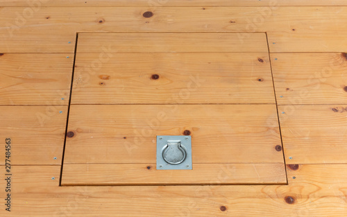 Wooden square old hatchway in the cellar