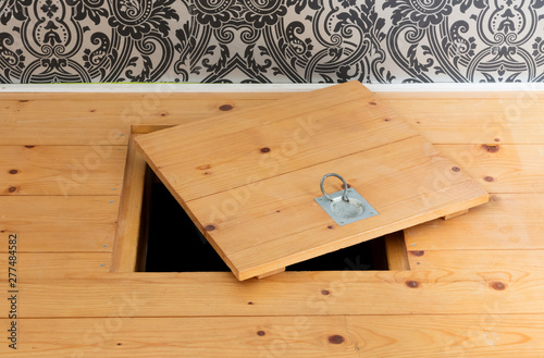 Wooden square old hatchway in the cellar