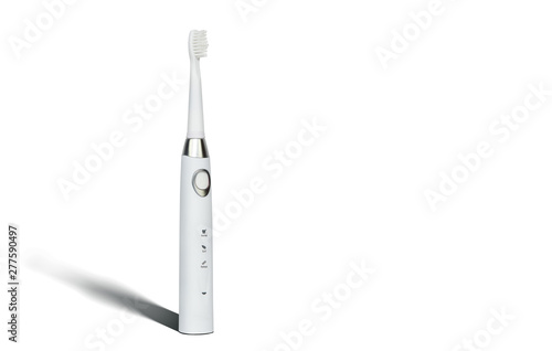 White sonic toothbrush for cleaning teeth on a white background. Medical and dental concept. Caring for teeth, modern methods of removing calculus from teeth. Electric toothbrush.