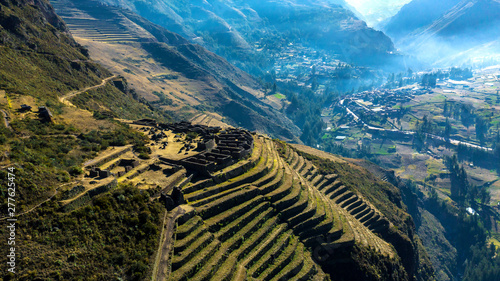 Aerial view of the ancient Inca ruins of Pisac (Pisaq) in the Sacred Valley near Cusco, Peru. Archaeological park with green terraces.