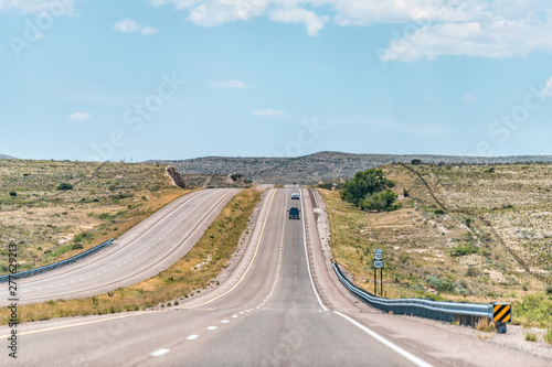 Roswell New Mexico countryside rural town road view from 380 highway with desert landscape and cars, sign for 70 west