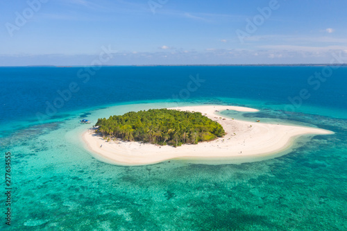 Patawan island. Small tropical island with white sandy beach. Beautiful island on the atoll, view from above. Nature of the Philippine Islands.