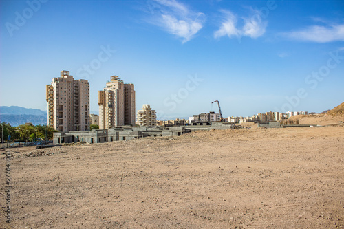 outskirts city street district scenic dry desert landmark with living houses and construction new buildings 