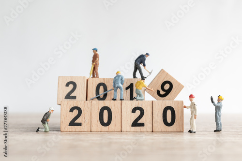Miniature worker team create number 2020 and remove number 2019 , Happy new year concept