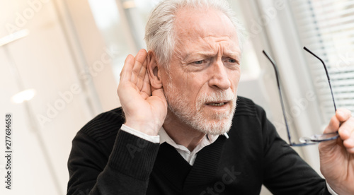 Senior man with hearing problems