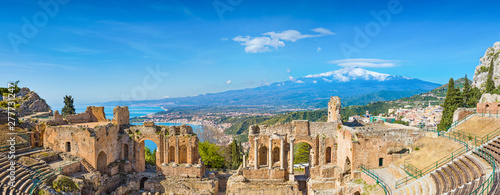 Ancient Greek theatre in Taormina on background of Etna Volcano, Italy