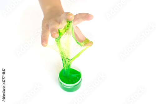 Modern toy called slime. Mucus in children hand on a white background. Selective focus. 