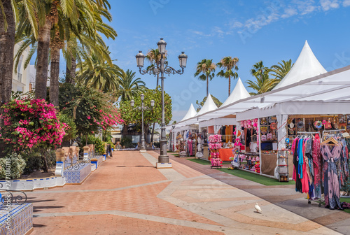 One of the main pretty squares in Ayamonte, Spain during the summer when there are stores selling clothes, sweets and souvenirs.