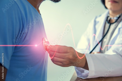 Asian female doctor checking patient heart rate in the hospital.