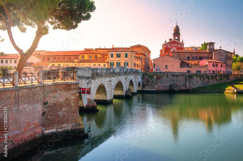 Tiberius bridge in Rimini historic centre, Italy. Scenic ancient stone bridge in morning sunrise