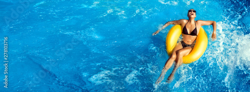 Summer vacation. Laughing young woman enjoying an aqua park. Fun in the pool