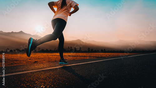 Woman enjoys running outside with beautiful summer evening in the countryside.