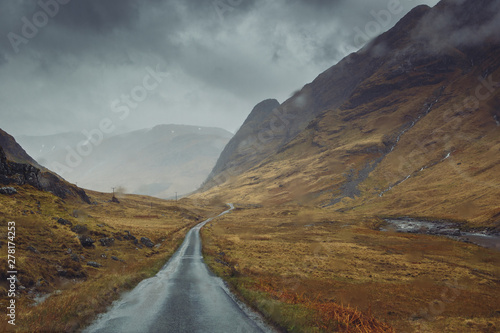 Beautiful scenic road in Glen Etive, Glen Coe Scotland. Skyfall landscape in rainy foggy weather.