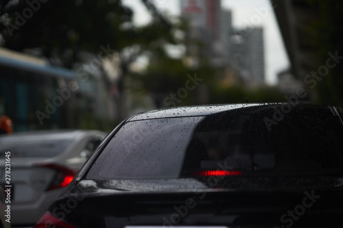 Rain drops on rear car mirror shield