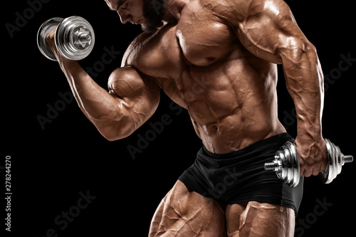 Muscular man doing exercises for biceps isolated on the black background. Bodybuilder male naked torso abs