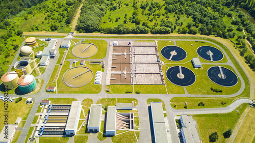 Aerial view of sewage treatment plant. Industrial water treatment for big city from drone view. Waste water management.