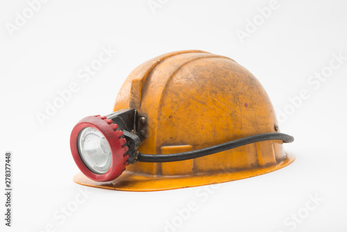 Old miner helmet with lamp on white background.