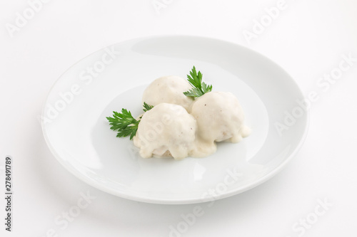 Fish meatball with white sauce and parsley isolated on white background