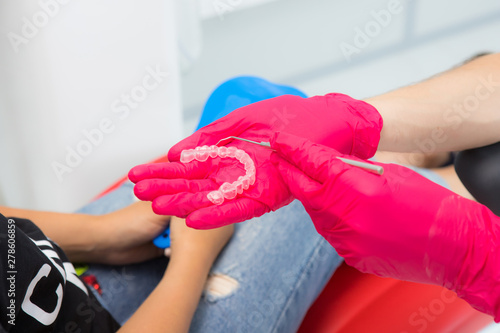 Doctor holds silicone glove mouth on hand.