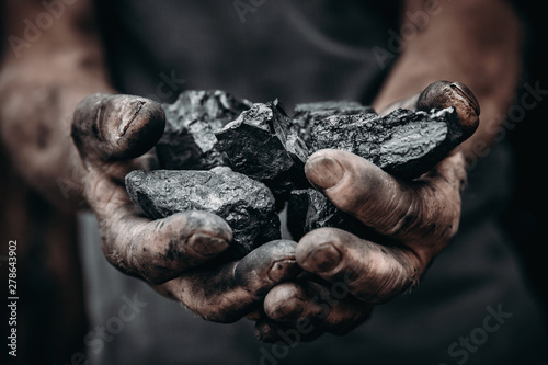 Coal in miner holds. Concept industry mining
