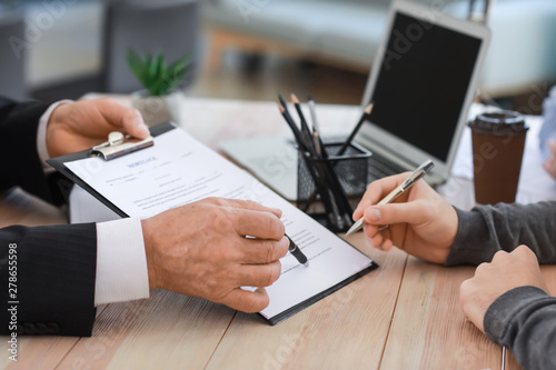 Man signing documents at notary public office