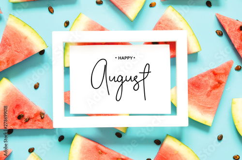 Inscription Happy August. Fresh red watermelon slice Isolated light blue background. Top view, Flat lay. - Image