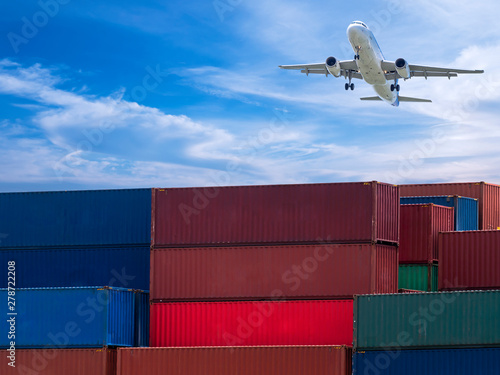 Airplane fly over container box in the cargo for import export with logistic or freight shipment industrial business under blue sky and white cloud