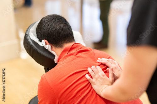 Man receiving shiatsu on a quick massage chair