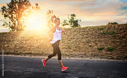 Shapely and athletic girl runs on a sunny day outside