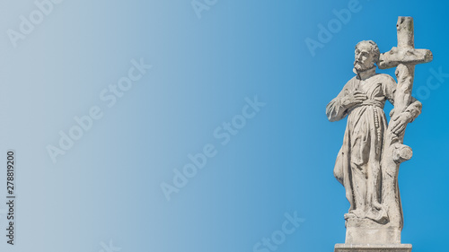 Decorative facade sculptures at Jesuit church of St. Ignatius of Loyola at Charles Square in Prague, Czech Republic, summer time, details, blue gradient background